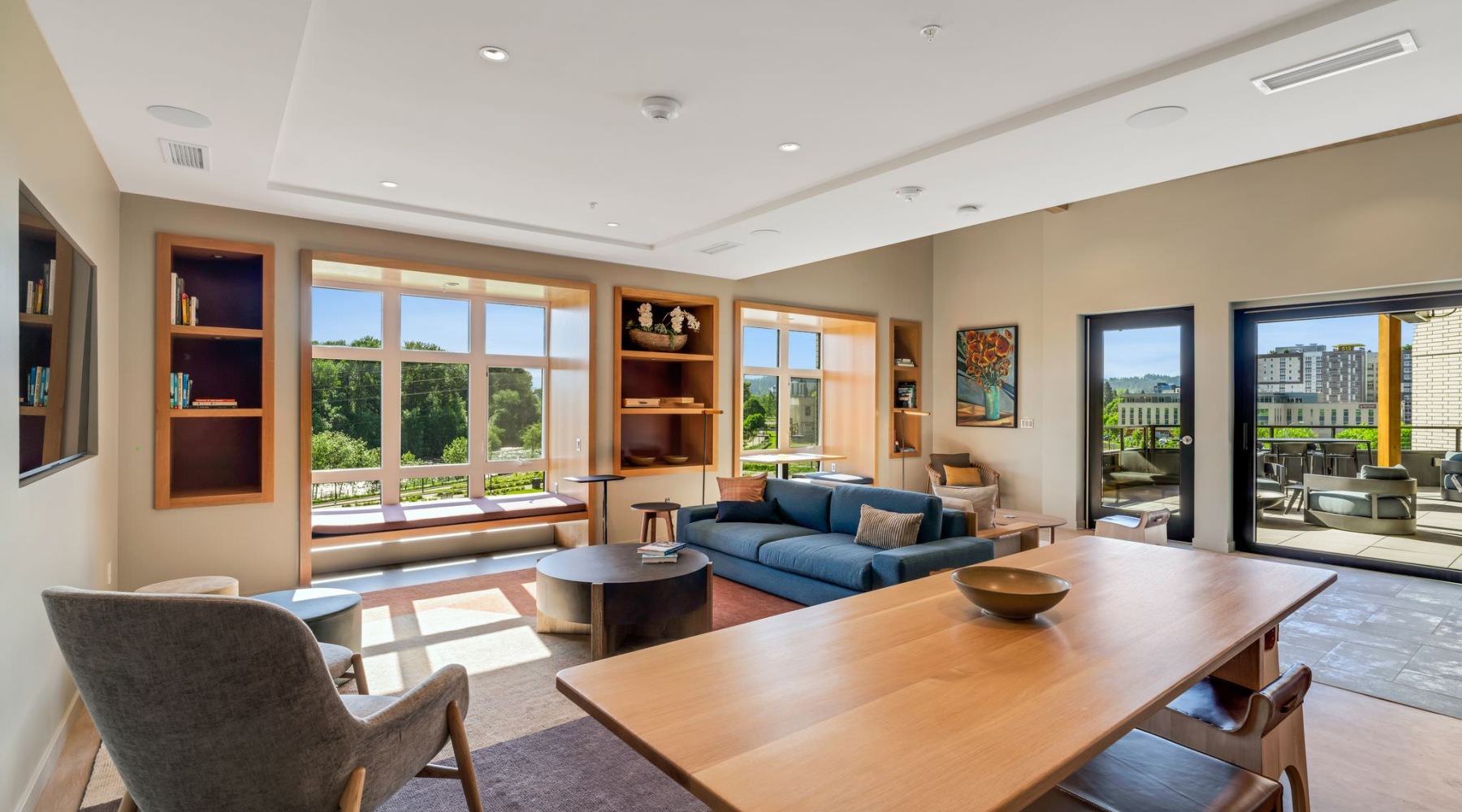 a clubroom with a couch, tables and chairs