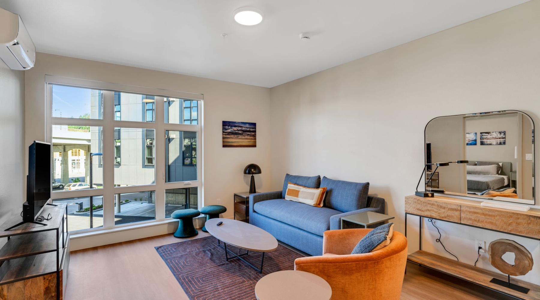 a living room with a couch, tables and chairs