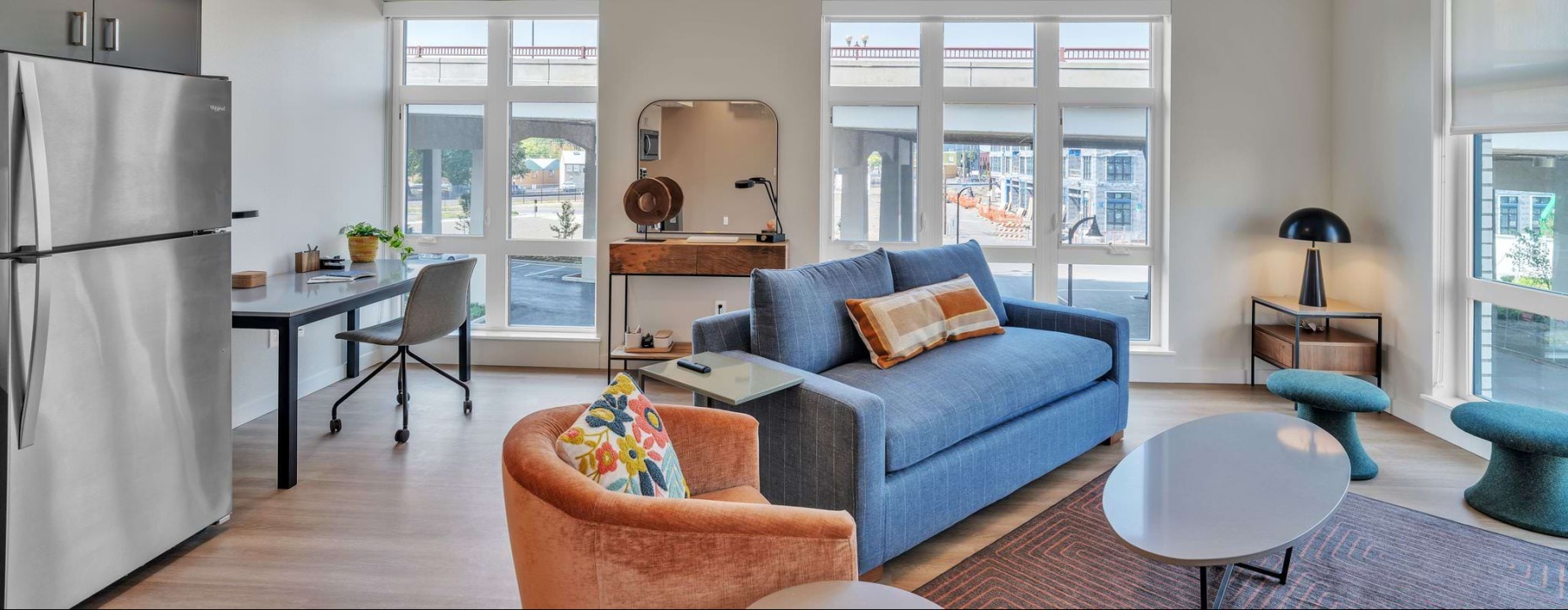 a living room with a blue couch and a table