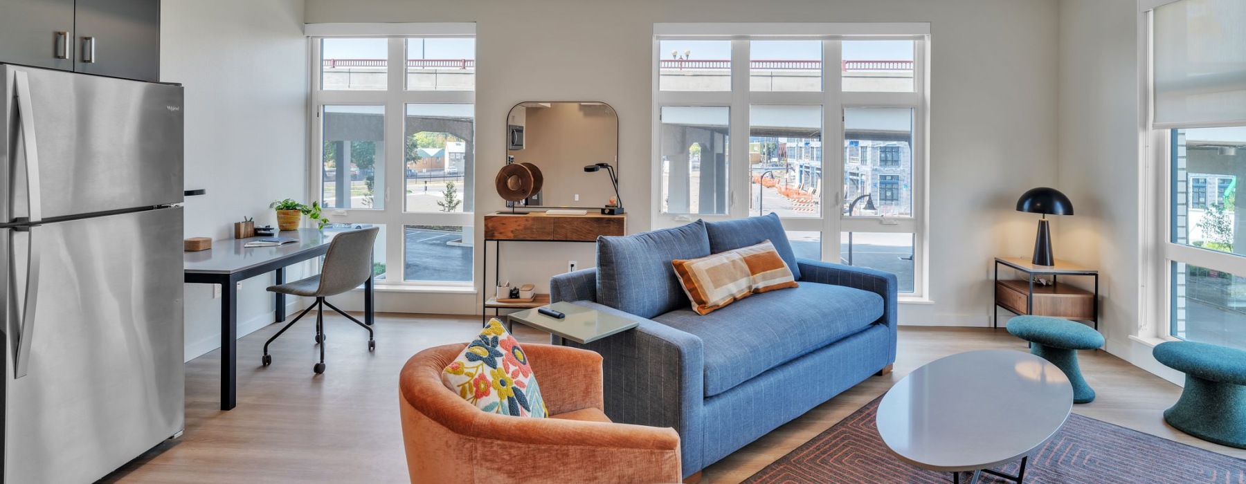 a living room with a blue couch and a table